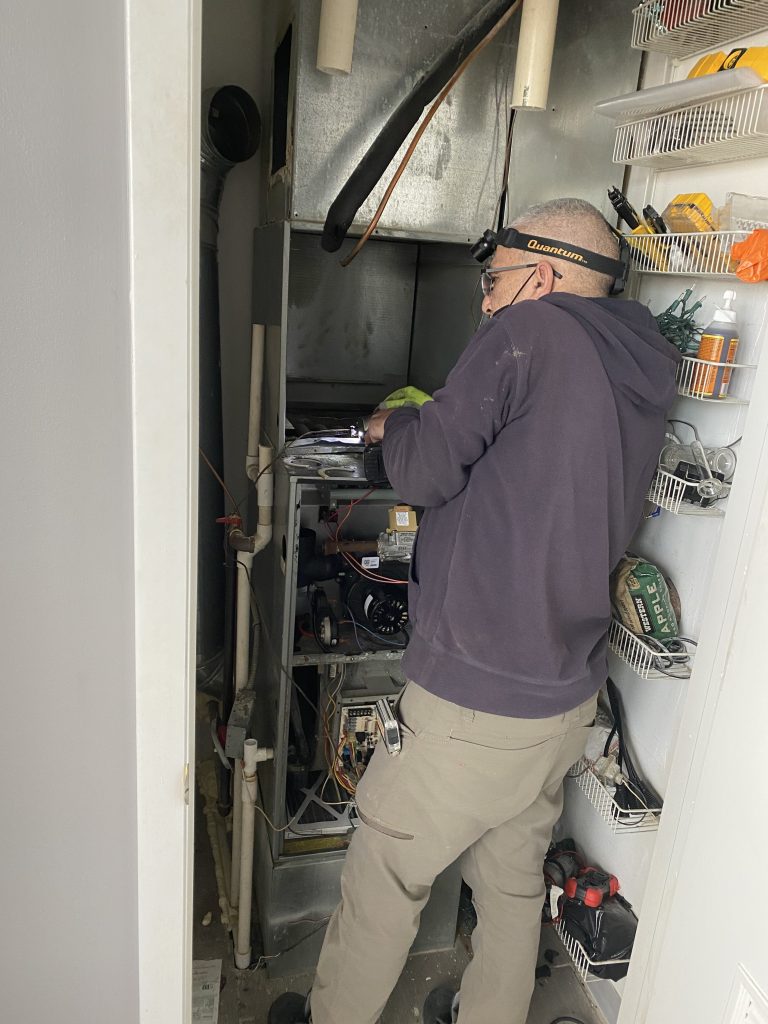 HVAC technician performing furnace maintenance in Des Plaines IL