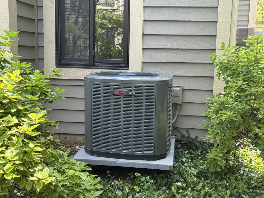 HVAC technician servicing residential air conditioning equipment